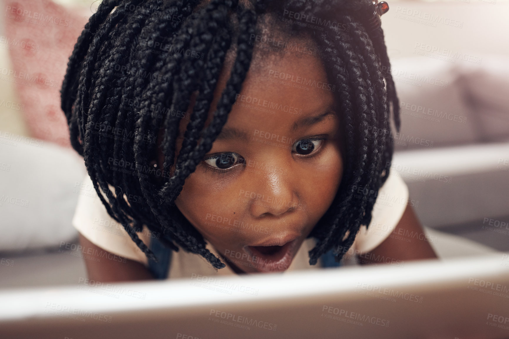 Buy stock photo Cropped shot of an adorable little girl having fun while using a digital tablet at home