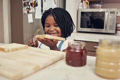 Buy stock photo Cropped shot of an adorable little girl making lunch for herself in the kitchen at home
