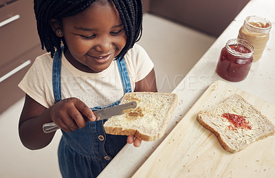 Buy stock photo Cropped shot of an adorable little girl making lunch for herself in the kitchen at home