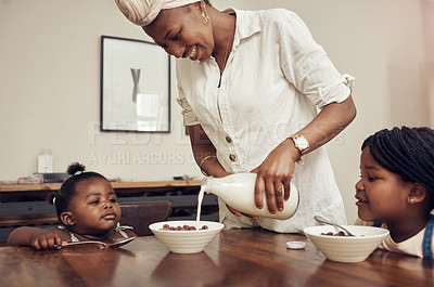 Buy stock photo Breakfast, cereal and family in dining room for eating, giving fiber meal or enjoy food together in morning. Relax, mother and black children for serving, hungry or growth development in home