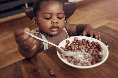 Buy stock photo Cropped shot of an adorable baby girl eating cereal for breakfast at home