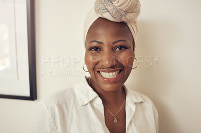 Buy stock photo Portrait of an attractive young woman wearing a turban relaxing at home