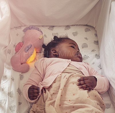 Buy stock photo Cropped shot of an adorable baby girl sleeping in her crib at home