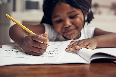 Buy stock photo Cropped shot of an adorable little girl drawing and doing her homework at home