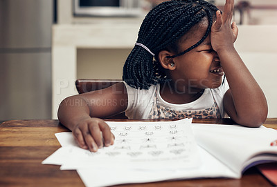 Buy stock photo Cropped shot of an adorable little girl thinking hard while doing her homework at home