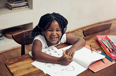 Buy stock photo Portrait of an adorable little girl drawing and doing her homework at home