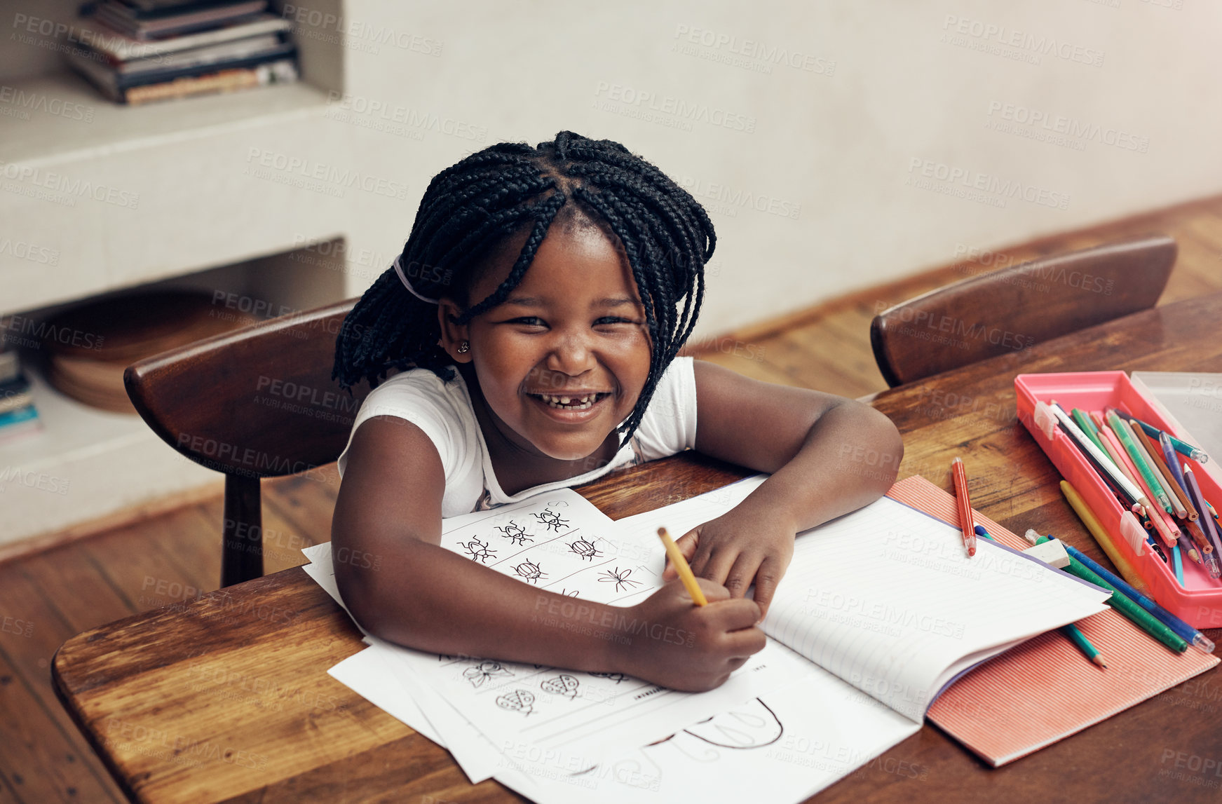 Buy stock photo Portrait of an adorable little girl drawing and doing her homework at home