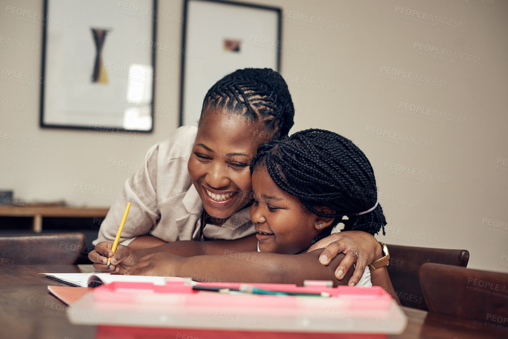 Buy stock photo Cropped shot of a mother helping her young daughter with her homework at home