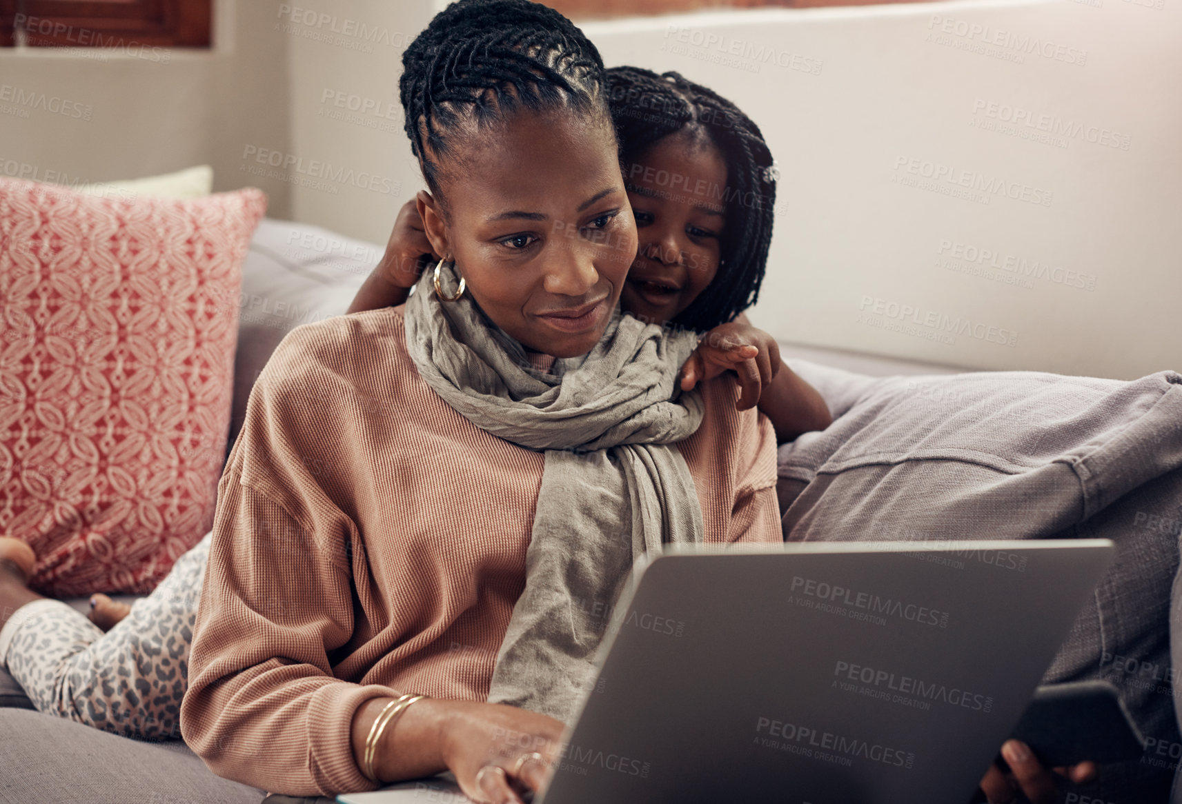 Buy stock photo Cropped shot of a young mother and daughter using a laptop while bonding together at home