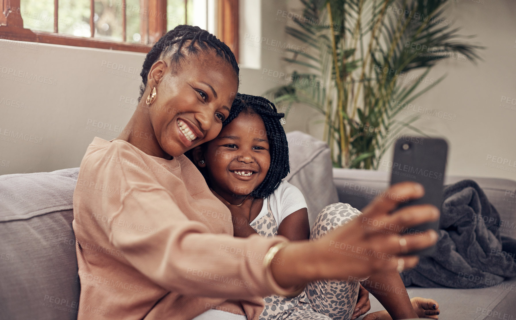 Buy stock photo Cropped shot of an adorable mother and daughter taking selfies together at home