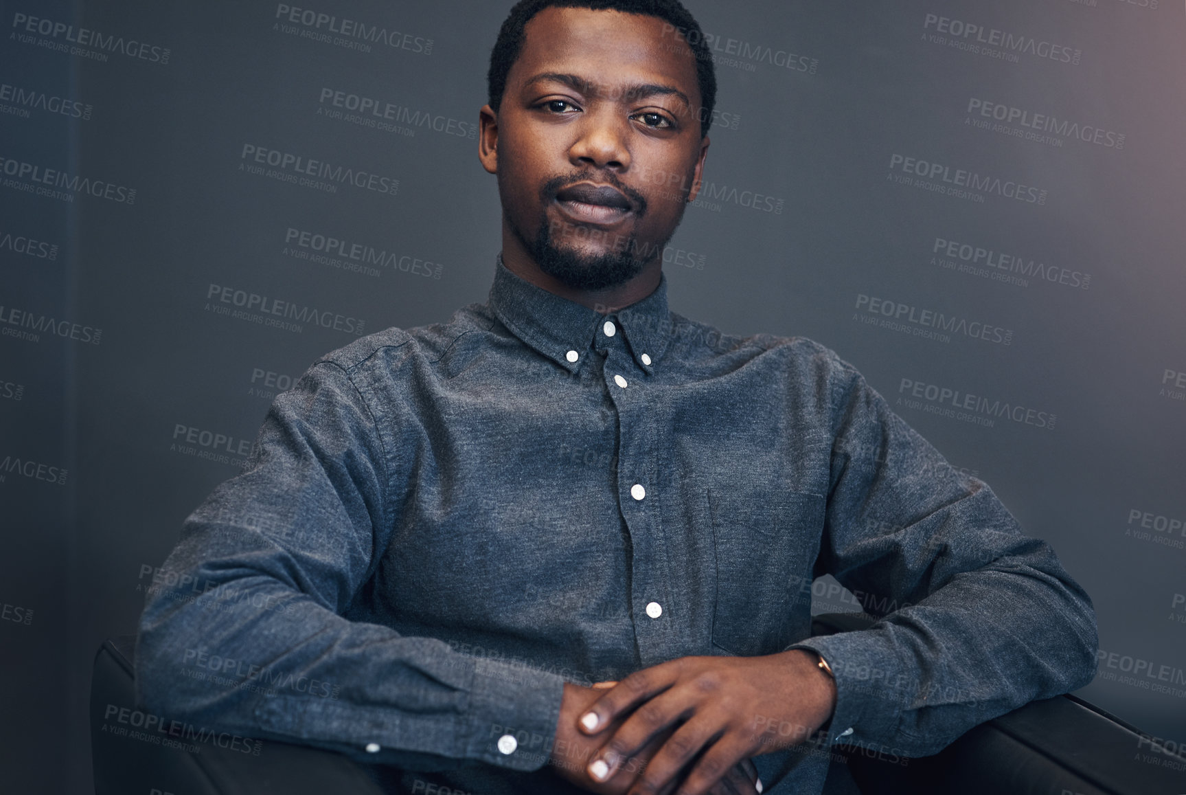 Buy stock photo Cropped portrait of a handsome young male architect sitting on a couch in a modern office