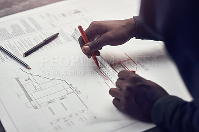 Buy stock photo High angle shot of an unrecognizable male architect making some measurements on his blueprints in a modern office