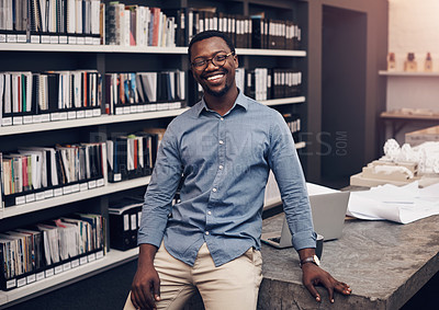 Buy stock photo Cropped portrait of a handsome young male architect smiling while standing in a modern office