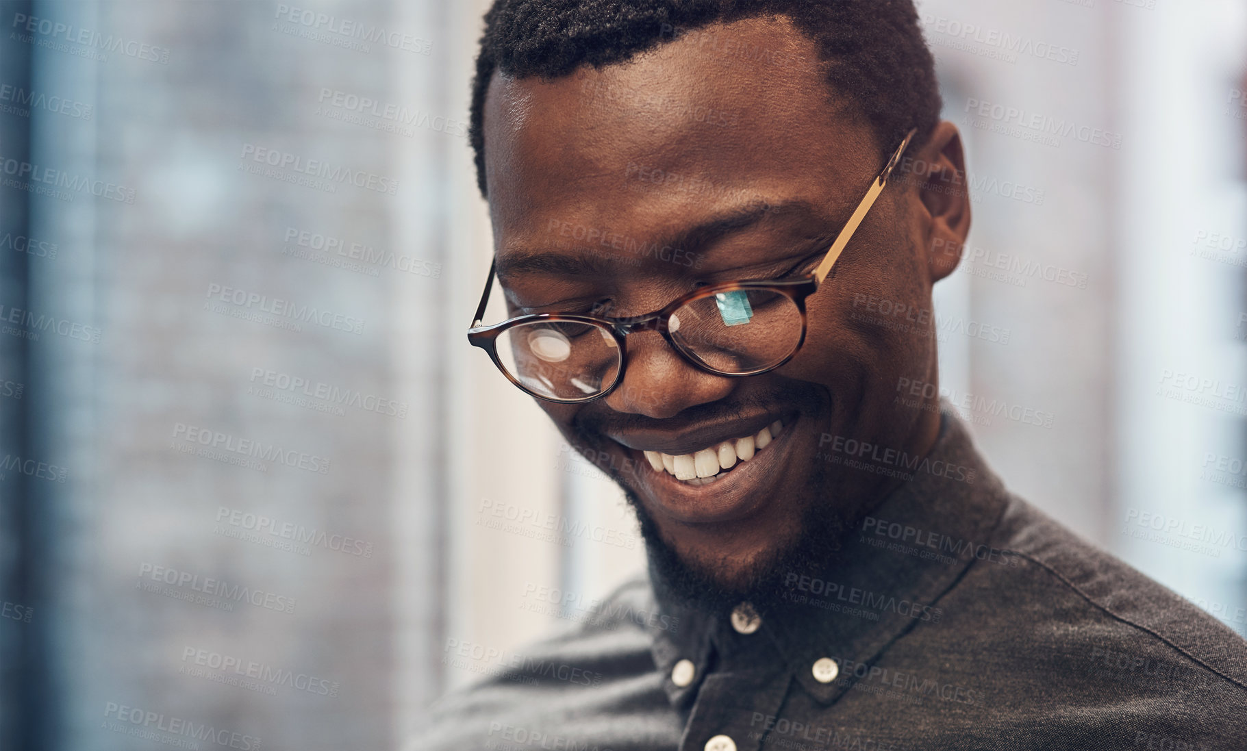 Buy stock photo Black man, smile and working in office with glasses for web design, professional or employee for corporate. Male person, creative agency and happiness at company or wellness, reading for career