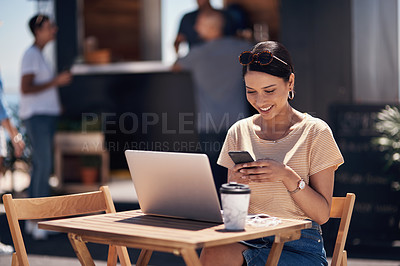 Buy stock photo Cropped shot of a cheerful young woman texting on her cellphone while doing work on her laptop next to a beach promenade outside during the day