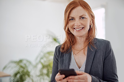 Buy stock photo Portrait of a mature businesswoman using a cellphone in an office