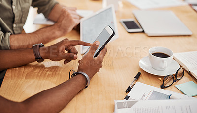 Buy stock photo Closeup shot of a two unrecognisable businessmen using a cellphone and digital tablet in an office