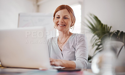 Buy stock photo Shot of a mature businesswoman working on a laptop in an office