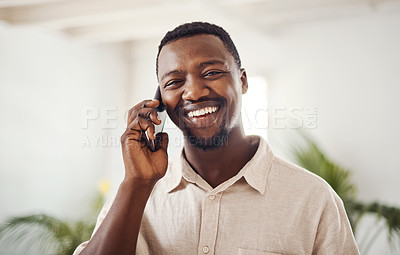 Buy stock photo Portrait of a young businessman talking on a cellphone in an office