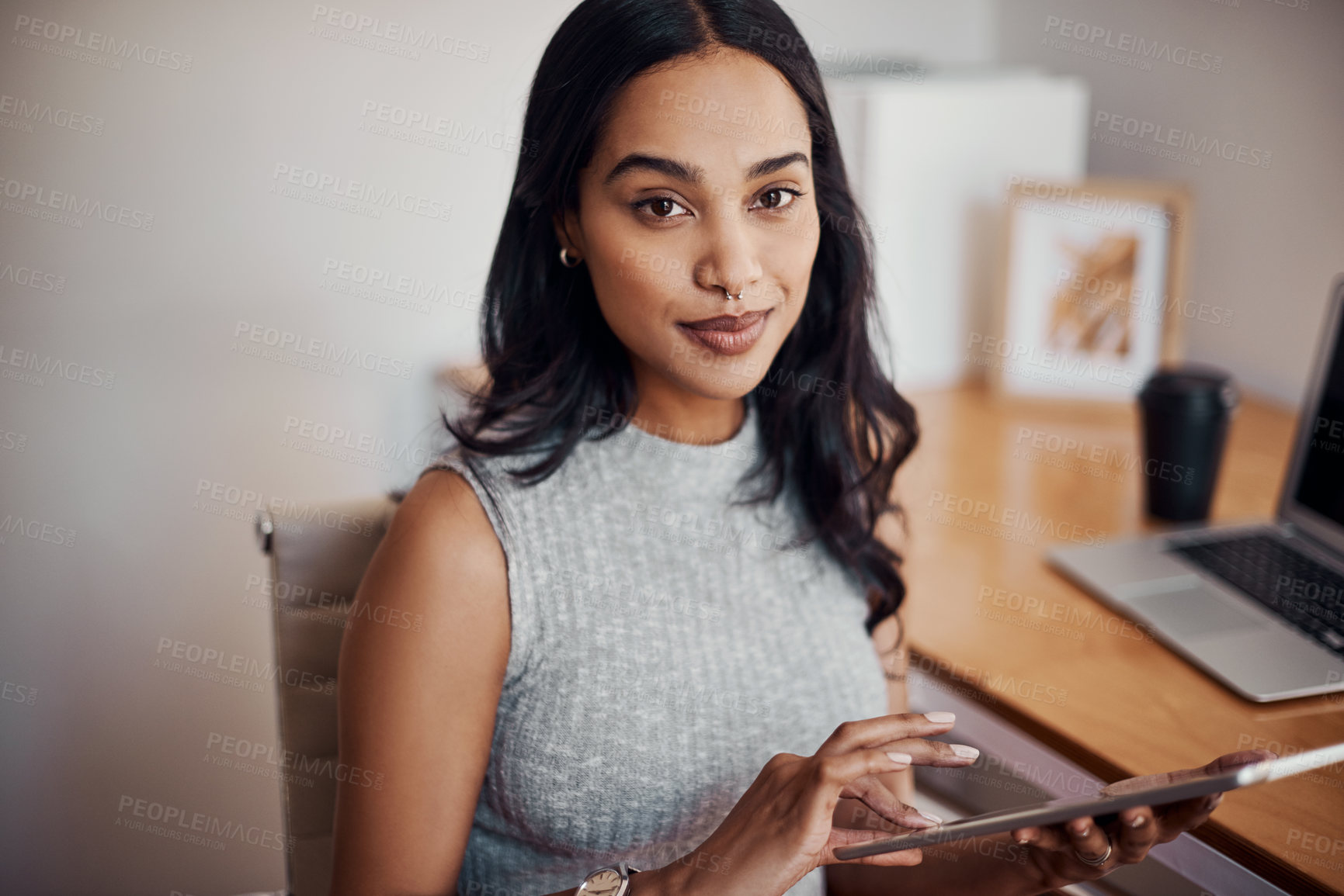 Buy stock photo Portrait of a young businesswoman using a digital tablet in an office