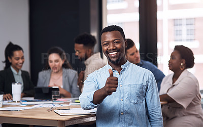 Buy stock photo Portrait of a young businessman showing thumbs up in an office with his colleagues in the background
