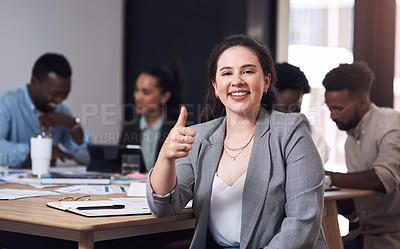 Buy stock photo Portrait of a young businesswoman showing thumbs up in an office with her colleagues in the background