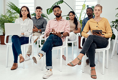 Buy stock photo Full length portrait of a diverse group of businesspeople sitting together for a presentation in the office