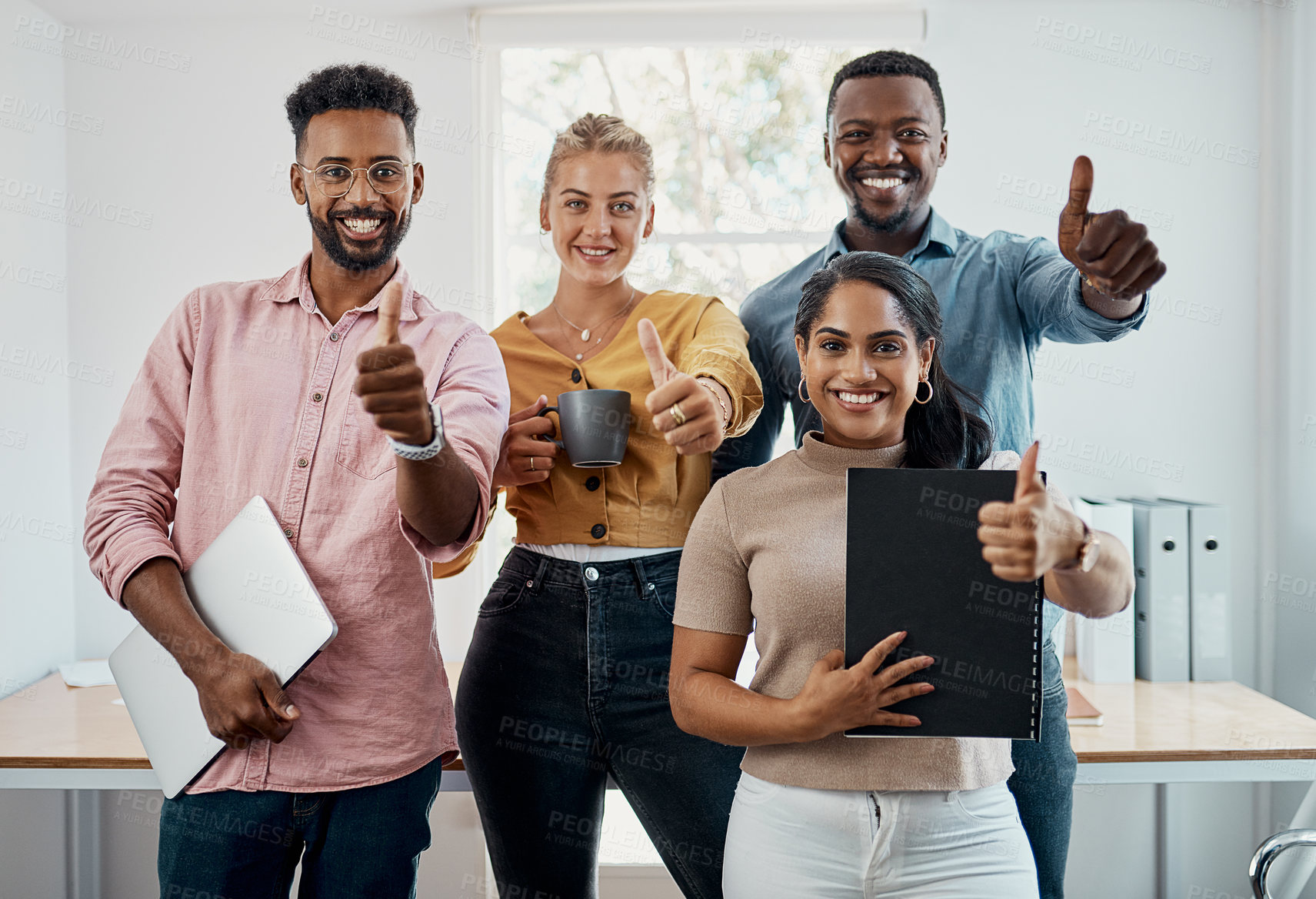 Buy stock photo Thumbs up, diversity and team in office with laptop for research, planning and agreement. Business, collaboration and people in creative agency for website design, review and feedback for project