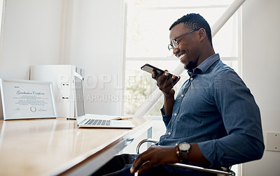 Buy stock photo Cropped shot of a handsome young businessman sitting alone in the office and sending voice notes on his cellphone