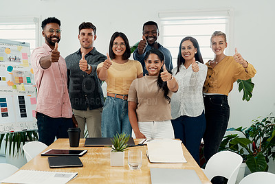 Buy stock photo Cropped portrait of a diverse group of businesspeople standing together and making a thumbs up gesture in the office
