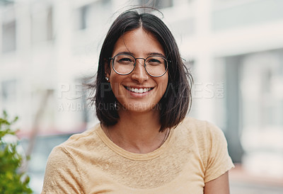 Buy stock photo Cropped portrait of an attractive young businesswoman sitting alone outside during the day