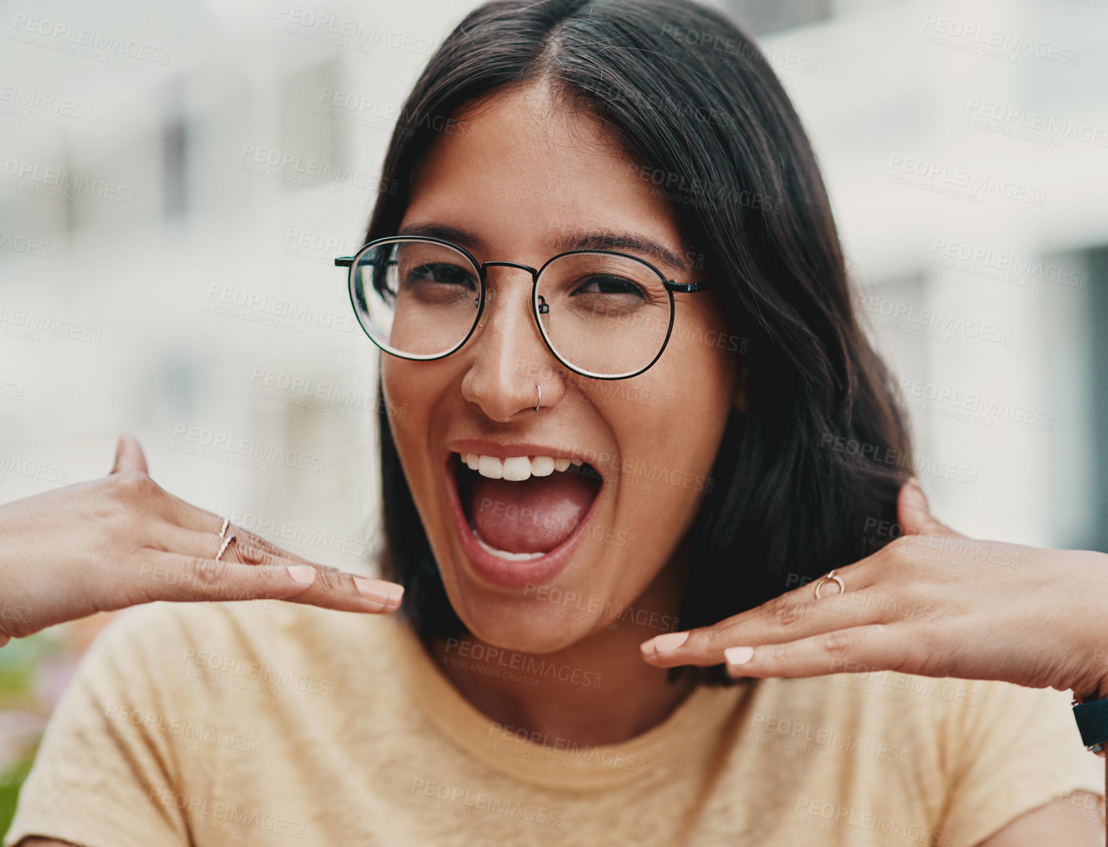 Buy stock photo Cropped portrait of an attractive young businesswoman sitting alone outside and feeling playful while making a face