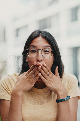 Buy stock photo Cropped portrait of an attractive young businesswoman sitting alone outside and feeling playful while making a face