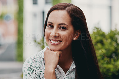 Buy stock photo Cropped portrait of an attractive young businesswoman sitting alone outside during the day