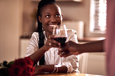 Buy stock photo Cropped shot of an affectionate young woman receiving a glass of wine from her husband at home