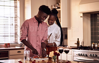 Buy stock photo Kitchen, black couple and smile with wine glass in cooking dinner for support, bonding and roses. Home, relationship and people for anniversary celebration, relax and romantic with meal and alcohol