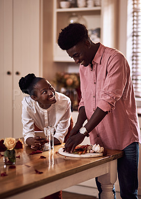 Buy stock photo Cooking, kitchen and black couple in house with wine cutting ingredients for romantic date night meal. Happy, phone and African man and woman preparing dinner or supper together with online recipe.