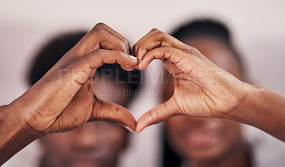 Buy stock photo Cropped shot of a young couple forming a heart shape by joining their hands