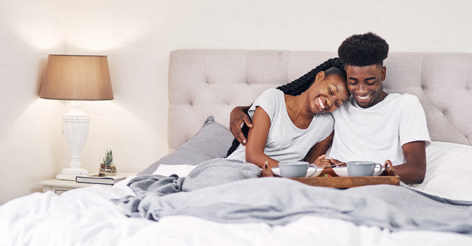 Buy stock photo Happy, black couple and relax in bed or breakfast, hotel and weekend getaway for romantic connection or bonding. Man, woman and together in motel for dating anniversary, laughing and commitment.