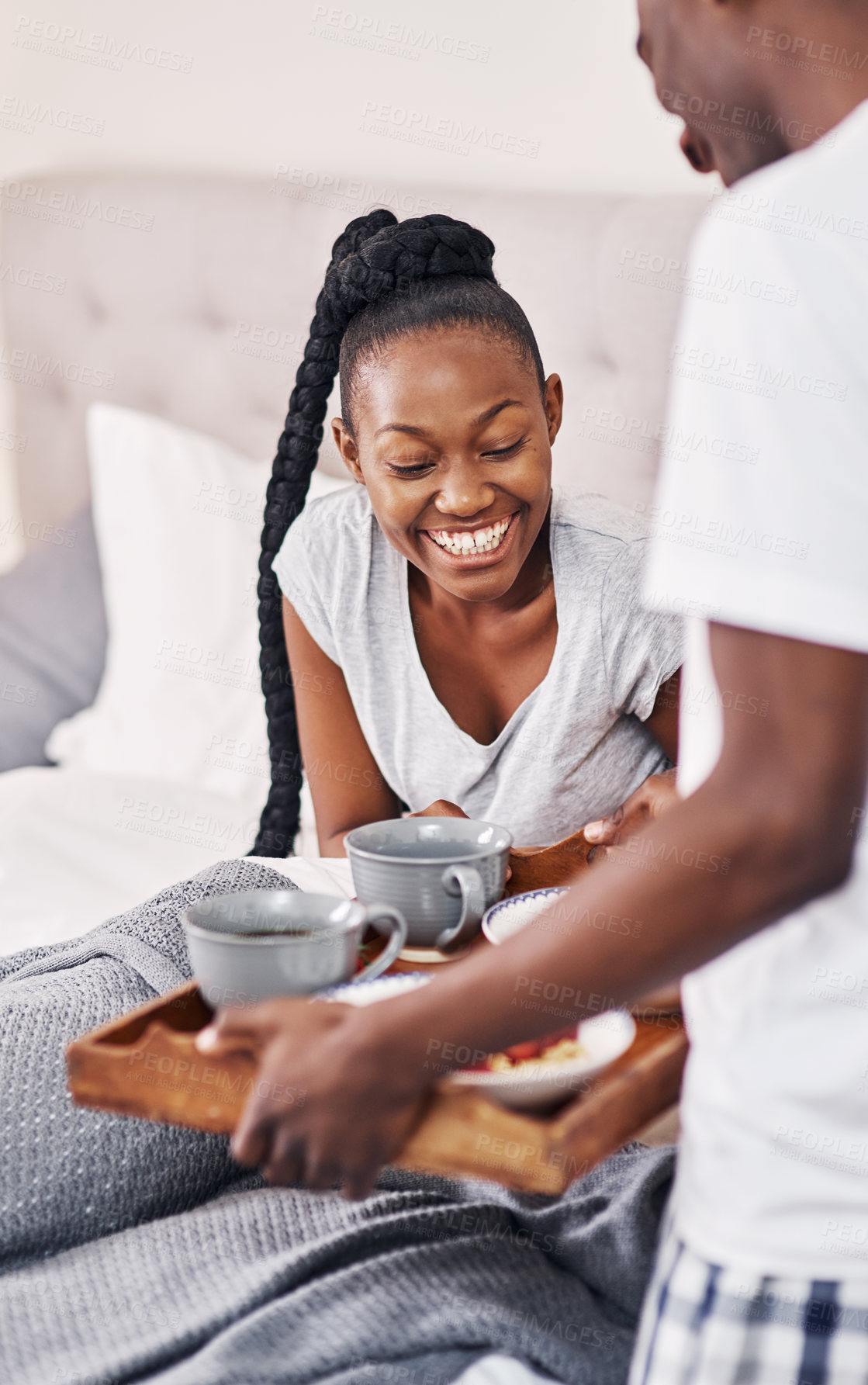 Buy stock photo Happy, black couple and serve breakfast in bed in home for morning, nutrition or diet. Man, woman and tray in bedroom with healthy food or coffee for love, romance and celebrate anniversary together