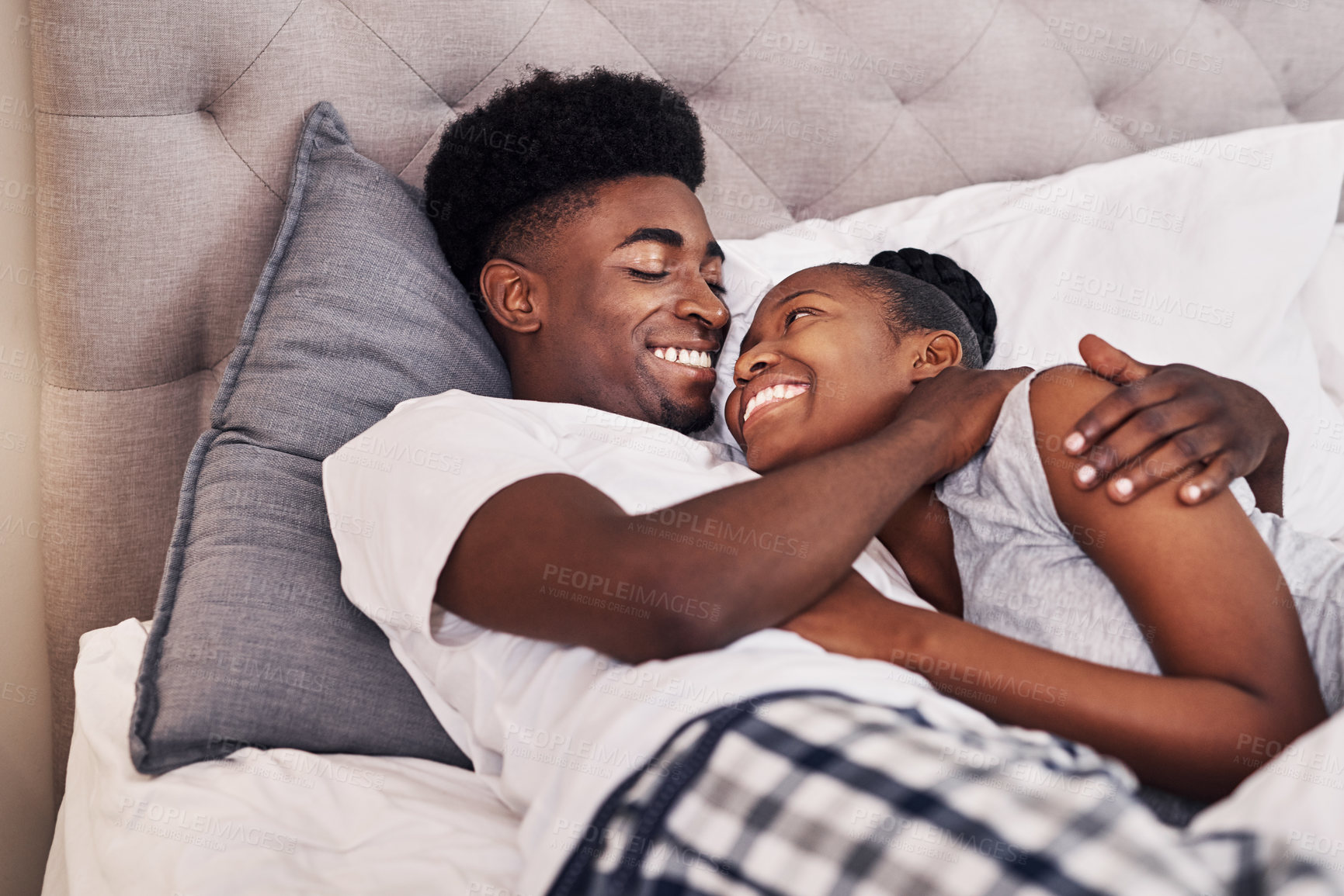 Buy stock photo Smile, black couple and relax with hug in bedroom for love, care and embrace of romance bonding in morning. Happy, man and woman with marriage commitment, trust and relationship support at house