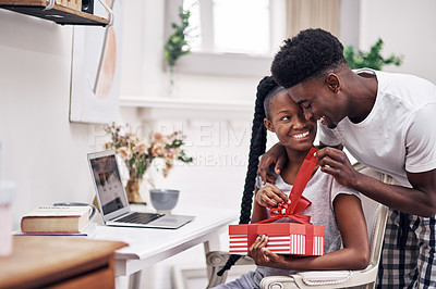 Buy stock photo Shot of a young man surprising his girlfriend with a present at home