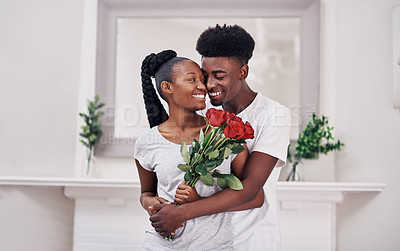 Buy stock photo Happy, roses and black couple hugging in home for anniversary or valentines day gift celebration. Love, connection and African man and woman embrace with flowers for romantic together at house.