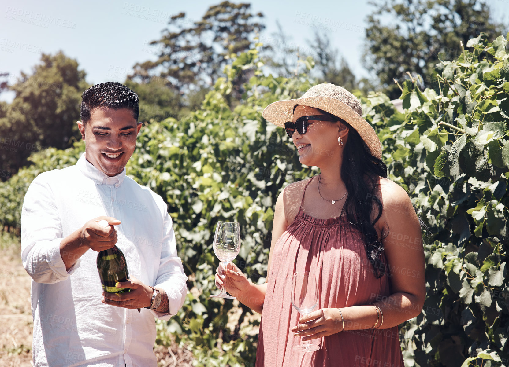 Buy stock photo Shot of a young couple out on a date at a vineyard