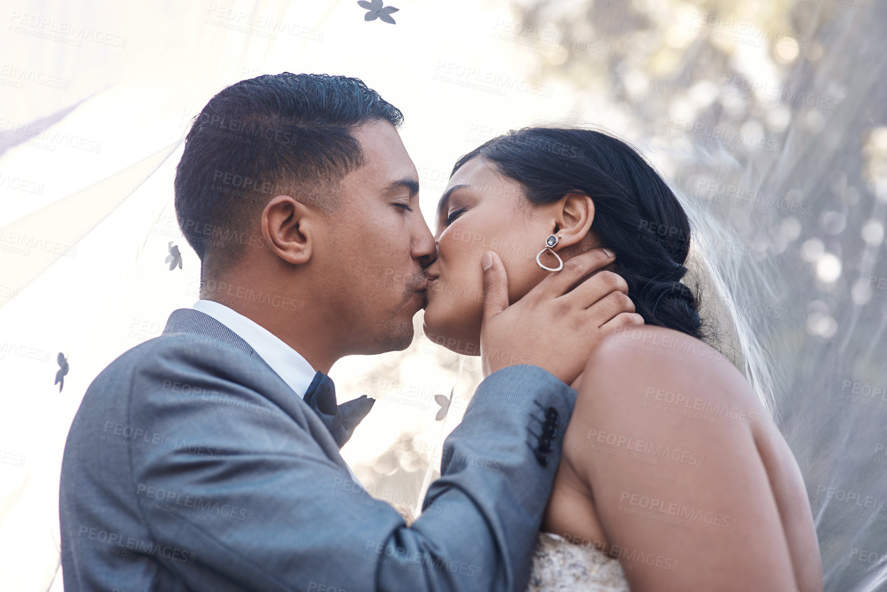 Buy stock photo Couple, happy and kiss on wedding day as celebration for love, commitment and success on marriage. Ceremony, woman and man at event as reception together, romance or outdoor with care on partnership