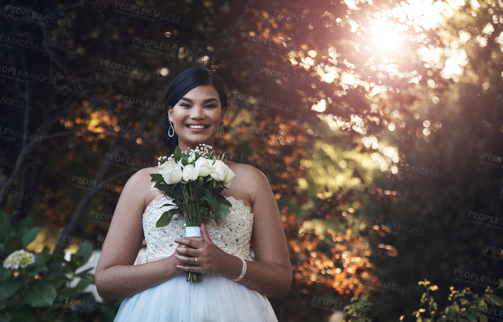 Buy stock photo Cropped shot of a young bride posing outside with her bouquet