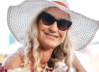 Buy stock photo Cropped portrait of an attractive senior woman smiling while standing outdoors on a summer's day