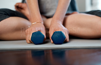 Buy stock photo Low angle shot of an unrecognizable woman practicing yoga while making use of weights inside of a studio during the day