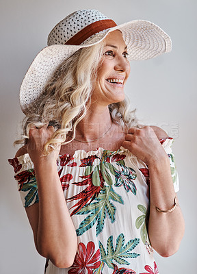 Buy stock photo Cropped shot of an attractive senior woman smiling while standing indoors on a summer's day