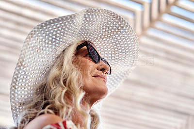 Buy stock photo Cropped shot of an attractive senior woman standing indoors on a summer's day